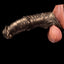 Oieffur Warhorse flexible penis sleeve extender with girth enhancement and cock ring, shown on a realistic silicone model.